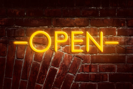 Neon inscription Open against the background of the old brick wall. Advertising. Businessの写真素材