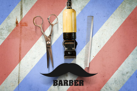 Hairdressing scissors, clipper and a hairbrush on a multi-colored concrete background. Inscription Barber. Professions. The concept of Barber Shop. Beauty and Fashionの写真素材