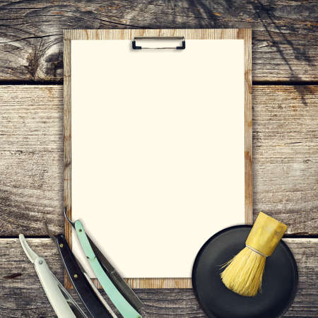 Concept of Barber Shop. Set of hairdressing tools and blank white sheet for text on a wooden background. Copy space. Beauty and Fashionの写真素材