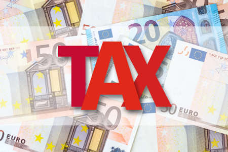 Tax. Inscription Against the background of Euro banknotes. Business, finance. Backgroundの写真素材