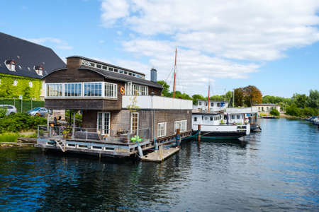 Copenhagen, Denmark - July 9, 2018. Beautiful ships and a house on the water on the canal. Water transport. Architecture. City landscape Travel.のeditorial素材