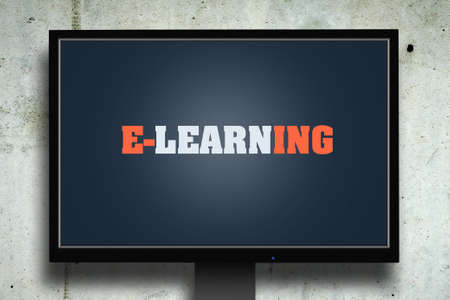 The inscription is E-Learning on the monitor screen against the background of the concrete wall. Education. Computerの写真素材