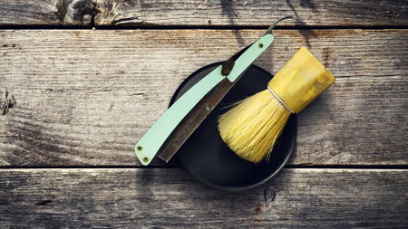 Concept Barber Shop. Old hairdresser's razor and shaving brush on a wooden background. Copy space Beauty. Fashionの写真素材