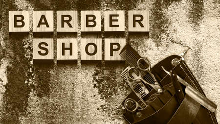 Concept Barber Shop. An inscription on wooden cubes against the background of an old vintage wall. Beauty. Fashionの写真素材