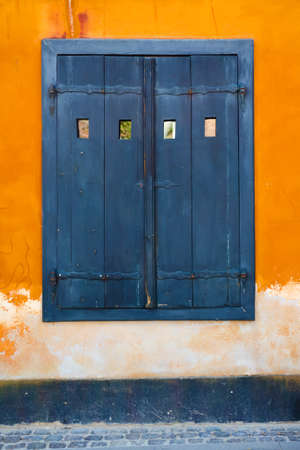 Old beautiful window on a yellow wall. Architecture. Backgrounds. Travelsの写真素材