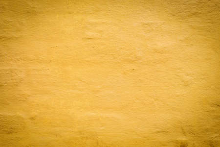 Old yellow stone wall background. Vintage wall. Backgrounds Texturesの写真素材