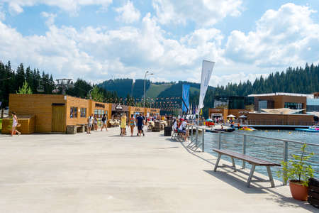 Bukovel. Ukraine. 17. July. 2021. Lake of Youth. A beautiful cafe and recreation area on the beach of a mountain lake. Carpathians. Summer rest. Travelsのeditorial素材