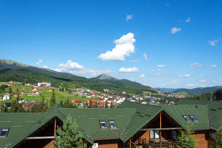 Nice view of cottages and hotels at the foot of the mountain. Ukraine. Bukovel. Carpathians. Summer rest. Tourism. Travels.の写真素材