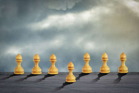 White pawn is ahead of the others. Cloudy sky. Leadership concept. Success. Abstraction. Business Backgroundの写真素材
