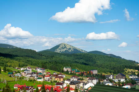 Nice view of cottages and hotels at the foot of the mountain. Ukraine. Bukovel. Carpathians. Summer rest. Tourism. Travels.のeditorial素材
