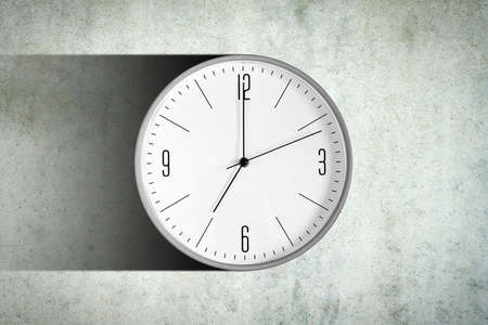 Clock on a concrete wall. Long shadow. Time concept. Business. Lifestyle Backgroundの写真素材