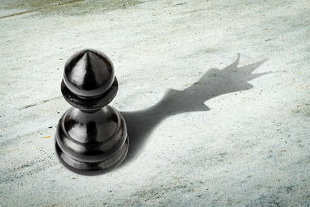 Pawn with the shadow of the queen. Motivation concept. Strength and aspirations. Confidence in your...