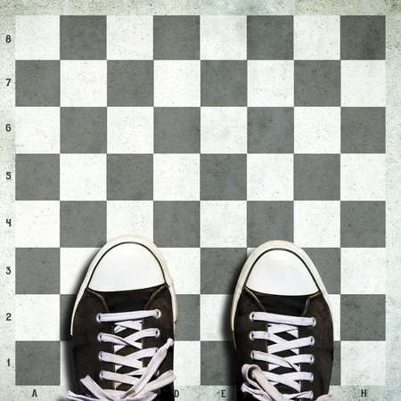 Sneakers on a chessboard. Strategy concept. View from above. Business. Lifestyle. Copy space Backgroundの写真素材
