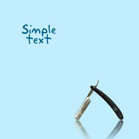 Razor with reflection on a blue background. Copy space. Barber shop background. Beauty and fashion background. Beauty salon background.の写真素材