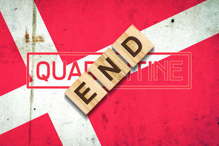 End of quarantine. The inscription on wooden blocks on the background of the flag of Denmark. The end of the pandemic. Business. Travels.の写真素材