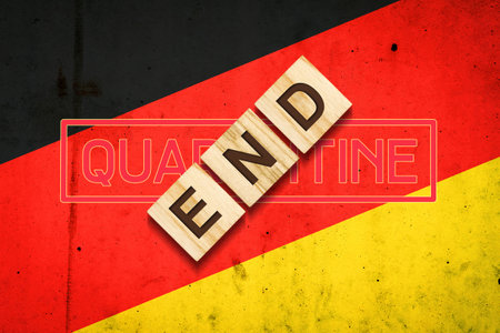 End of quarantine. The inscription on wooden blocks on the background of the flag of Germany. The end of the pandemic. Business. Travels.の写真素材