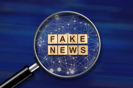 World economy. Small inscription on wooden blocks on a dark blue background. View through a magnifying glass. The fall of the economy. Business. Finance.の写真素材