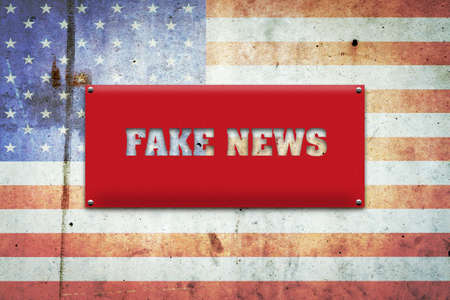 Fake news. The inscription on a red plate on the background of the flag of America. Information.Technologies.の写真素材