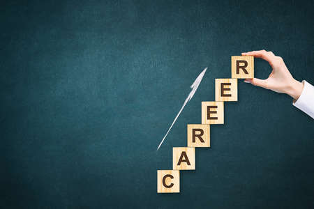 Career. The inscription on the wooden blocks. Copy space. Dark background. Start. Success.の写真素材