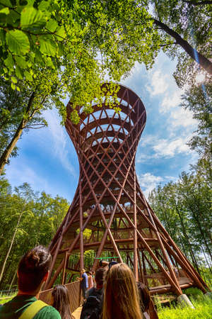 R nnede. Denmark. July 27, 2019 Camp of the Adventure Tower of the Year. People look at the observation tower in the forest. View from below. Sights. Travel. Tourism Architectureのeditorial素材