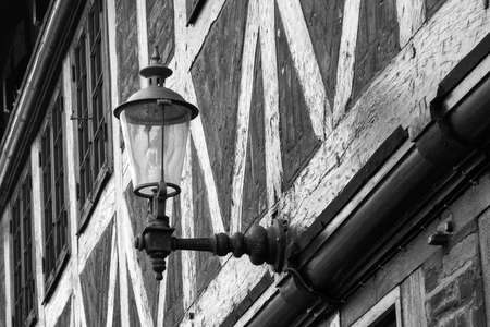 Beautiful vintage street lamp on a brick wall. Black and white photo. Architecture. Detailsの写真素材