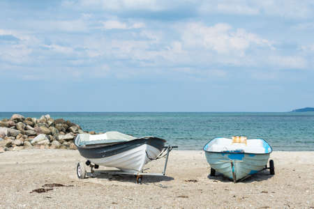 Boats on a sandy beach, against the background of the sea. North Sea. Denmark. Water transport. Summer rest.の写真素材