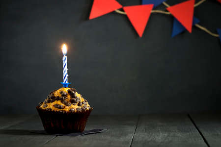 Birthday cupcake on a dark background. Holidays. Happy Birthday. Postcard. Congratulations
