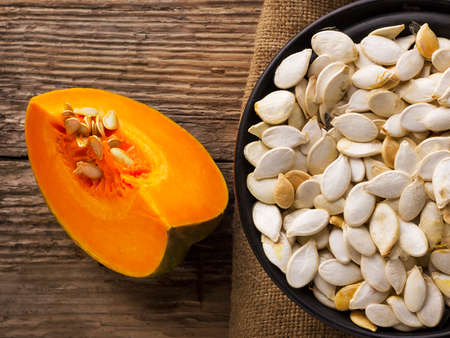 Pumpkin seeds with a piece of ripe juicy pumpkin. Harvest. Autumn.