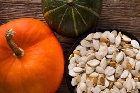 Pumpkin seeds with a piece of ripe juicy pumpkin. Harvest. Autumn.の写真素材