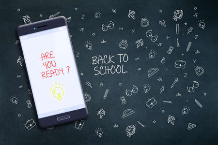 Inscription Back to school, you are ready, on the screen of a mobile phone. Against the background...