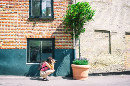 Young girl photographs a city landscape. People. Hobbies. Work.