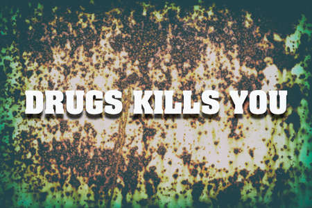 Concept Drugs are killing you. The inscription on the background of old rusty iron. The fight against drugs. Healthy lifestyle.の写真素材