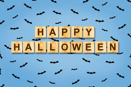 Happy Halloween, lettering on wooden blocks on a blue background. Festive background. Background.