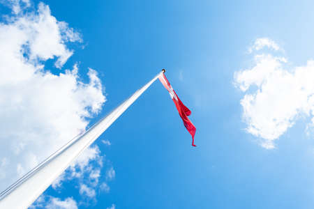 Flag of Denmark against the blue sky. Bottom viewの写真素材