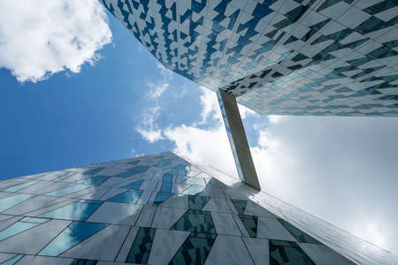Copenhagen. Denmark. July 24th. 2019: Facade of a glass building. Cloudy sky Bottom view. Close-up. Architecture Backgroundsのeditorial素材