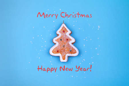 Happy New Year and Merry Christmas. Christmas gingerbread on a blue background. Greeting card....