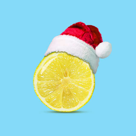 Slice of lemon in a hat of Santa Claus. Isolated. Healthy lifestyle concept. Healthy lifestyle. Background.の写真素材