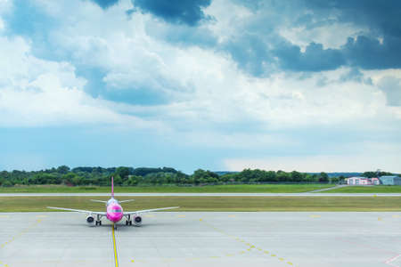 Airplane parked at the airport, beautiful cloudy sky. Transpot. Travels.のeditorial素材