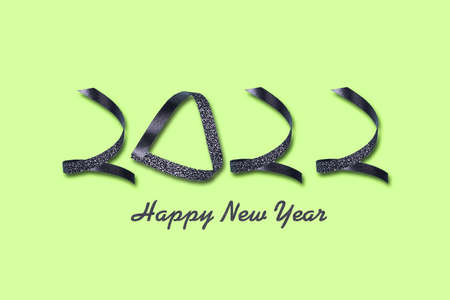 2022. Made up of ribbons on a yellow background. New Year background. Festive background.