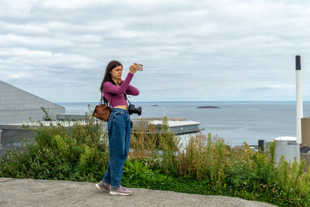 Pretty woman takes a selfie. Amager Bakke. Copenhill. Copenhagen. Denmark Tourism Trips