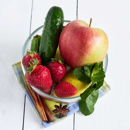 Fresh vegetables and fruits in a glass bowl. Strawberry, apple, cucumber, lemon and mint. Healthy way of life. Healthy food ..の写真素材