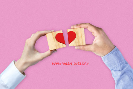 Women and Men hands make up a heart on wooden blocks. Happy Valentine's day background. Holiday background.の写真素材