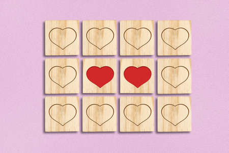 Hearts on wooden blocks on a pink background. Valentine's Day, Mother's Day, Wedding background....