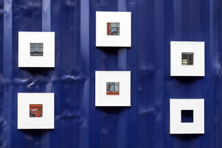 Small mirrors on a blue iron wall. The design of the exteriors. Architecture. Detailsの写真素材