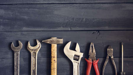 Variety of tools for wrenches on a dark wooden table. Copy space. Concept Happy Father's Day....