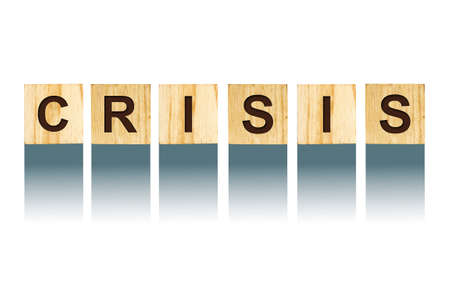 Word Crisis, composed of letters on wooden construction cubes. White background, isolated Concept business, finance. Backgrounds.の写真素材
