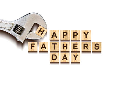 Happy Father's Day inscription on wooden cubes with working tools on white background, isolated. Happy Father's Day Concept. Greetings and gifts.の写真素材