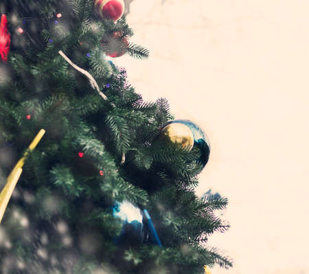 Christmas tree with ornaments and garlands of toys and snow