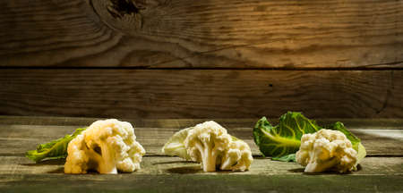 Fresh Cauliflower with leaves on the wooden backgroundの写真素材