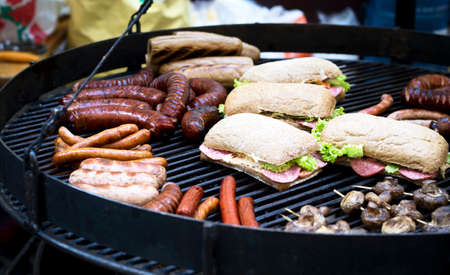 Street food, barbecue, meat, sausages and sandwiches cooked on the grill.の写真素材